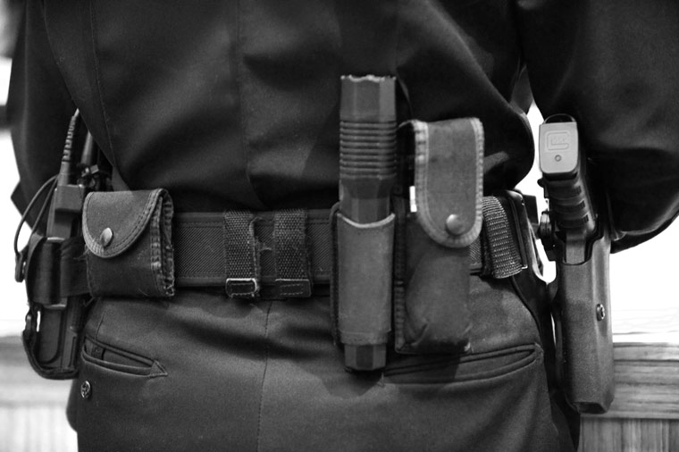 police from behind, the toolbelt, revolver, flashlight