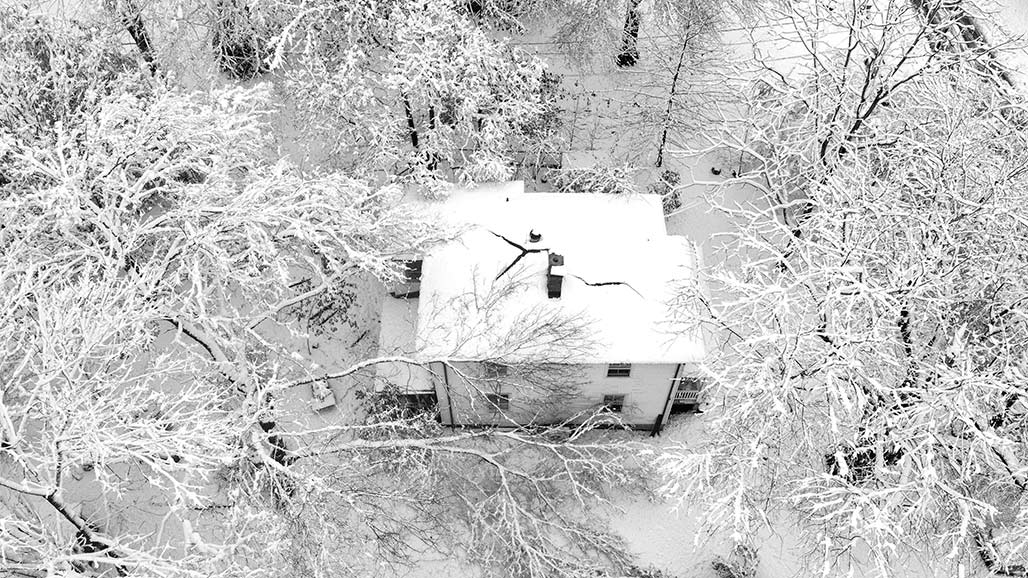aerial house trees snow